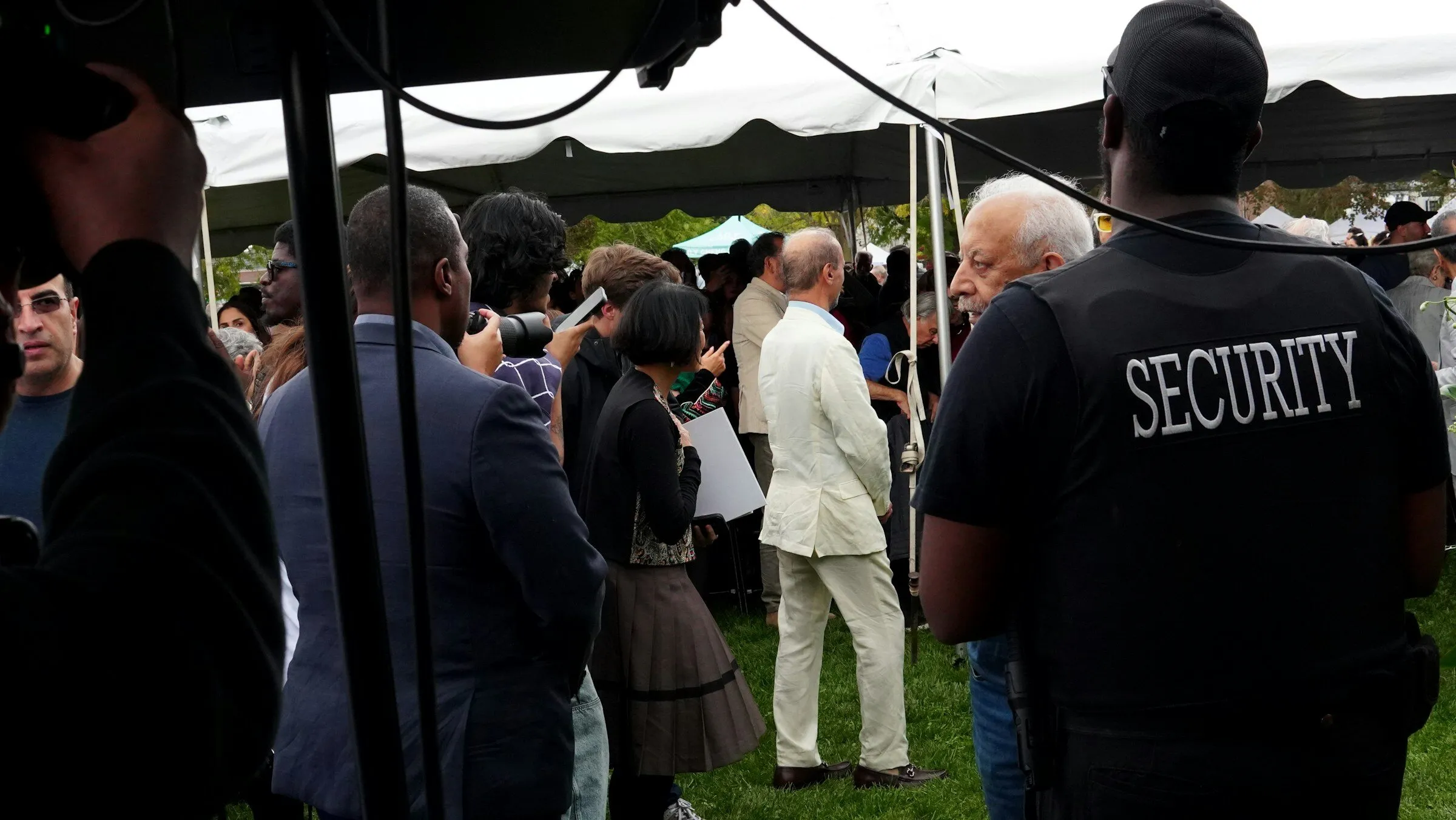 A security guard watching over the crowd at an outdoor event